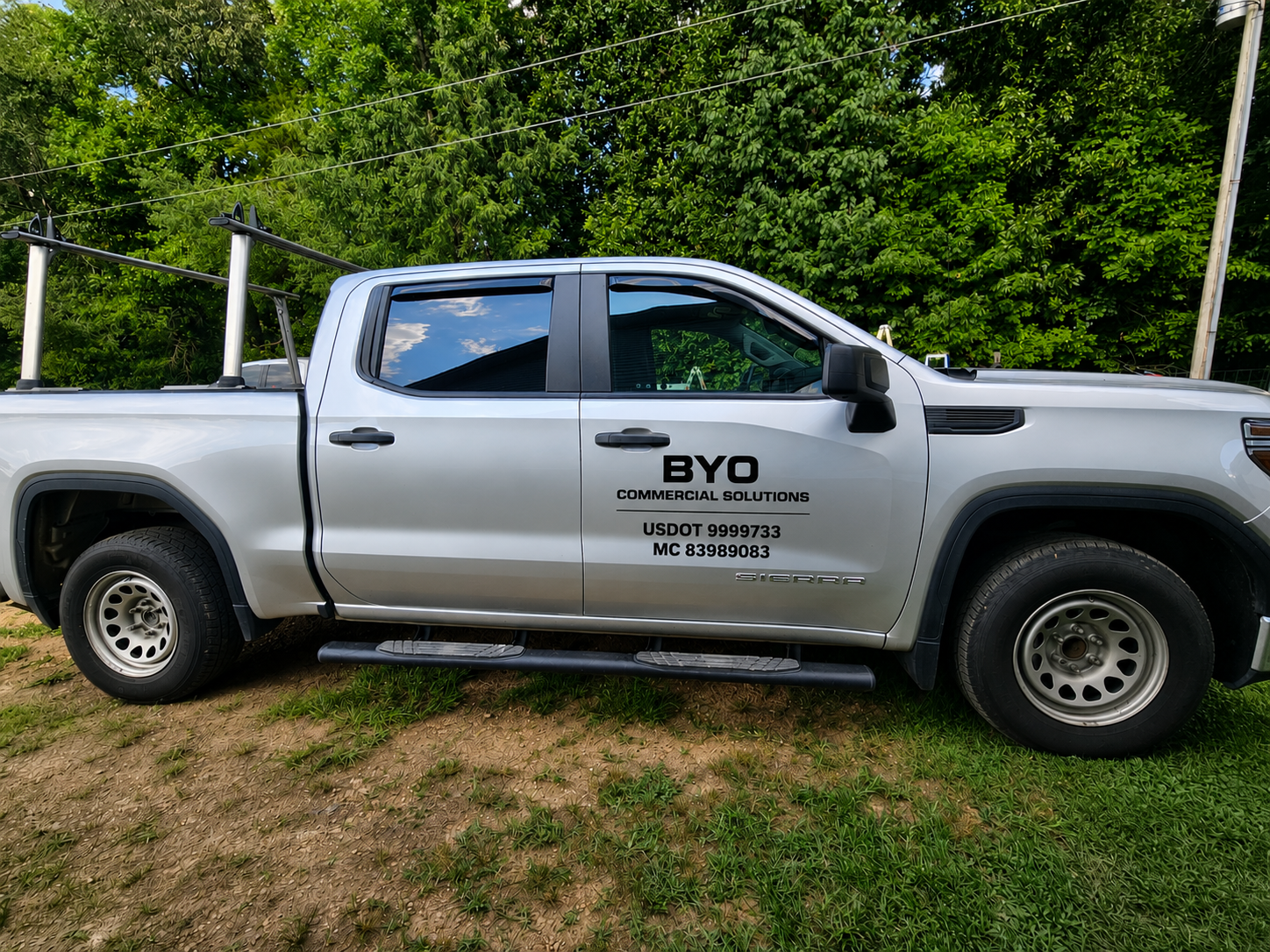 BYO Commercial Solutions hauling construction materials on a flatbed trailer